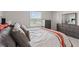 Bright bedroom with large window and dresser, offering a peaceful retreat at 17620 Crescent Moon Loop, Bradenton, FL 34211