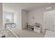 Bright, carpeted bedroom with a comfortable reading nook and a playful nautical themed wall decoration at 17620 Crescent Moon Loop, Bradenton, FL 34211