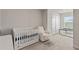 Adorable Bedroom with crib, rocker, and playpen, creating a cozy space for baby at 17620 Crescent Moon Loop, Bradenton, FL 34211