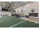 Large gymnasium featuring fitness equipment, turf field, and a basketball hoop at 17620 Crescent Moon Loop, Bradenton, FL 34211