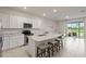 Stylish kitchen featuring a spacious island, modern appliances, and a seamless flow into the living area at 17620 Crescent Moon Loop, Bradenton, FL 34211