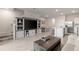 Spacious living room with entertainment center, open to kitchen and dining area at 17620 Crescent Moon Loop, Bradenton, FL 34211