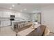 Open concept living space with a kitchen island, dining space, and a comfortable living area at 17620 Crescent Moon Loop, Bradenton, FL 34211