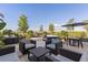 Stylish patio featuring plush seating, tables, and a shaded umbrella, perfect for relaxing outdoors at 17620 Crescent Moon Loop, Bradenton, FL 34211