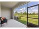 Screened patio with view of well-maintained backyard, offering outdoor living space at 17620 Crescent Moon Loop, Bradenton, FL 34211