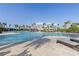 Large community pool with lounge chairs and swaying palm trees provides a relaxing vacation atmosphere at 17620 Crescent Moon Loop, Bradenton, FL 34211