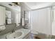 Cozy bathroom featuring a classic vanity, toilet, and shower with curtain at 2105 Georgia Ave, Englewood, FL 34224