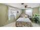 Bright bedroom with a ceiling fan, comfy bed, and decorative touches that create a relaxing atmosphere at 2105 Georgia Ave, Englewood, FL 34224