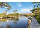 Picturesque waterfront dock, with boats, offers a scenic escape for relaxation and outdoor activities at 2105 Georgia Ave, Englewood, FL 34224