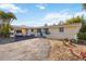 Inviting single-story home with a covered carport, decorative white fencing, and a double-door entryway at 2105 Georgia Ave, Englewood, FL 34224