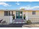 Charming home exterior with lush landscaping, decorative lamps, and inviting double door entrance at 2105 Georgia Ave, Englewood, FL 34224