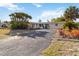 Well-maintained single-story home with a large front yard, mature palm trees, and a double-door entryway at 2105 Georgia Ave, Englewood, FL 34224