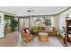 Cozy living room features wood-look floors, a large sectional, and windows providing natural light at 2105 Georgia Ave, Englewood, FL 34224