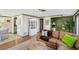 Spacious living room with wood-look floors, and open access to the kitchen and dining areas at 2105 Georgia Ave, Englewood, FL 34224