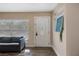 Bright foyer with hardwood floors, modern art display, and a comfortable blue sofa at 2128 Harley Ave, Sarasota, FL 34235