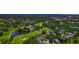 An aerial view of a golf community with winding creeks and ponds at 223 Saint James Park, Osprey, FL 34229