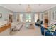 Elegant living room with access to outdoor pool, featuring hardwood floors and stylish furniture at 223 Saint James Park, Osprey, FL 34229