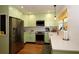 Bright kitchen with light green cabinets, stainless steel appliances, and a farmhouse sink at 230 47Th W St, Bradenton, FL 34209