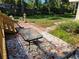 Enjoy outdoor dining on this patio with mosaic tiles, accessible from the home and overlooking the backyard at 230 47Th W St, Bradenton, FL 34209