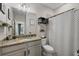 Well-lit bathroom with a black and white shower curtain and granite countertops at 232 Explorer Dr # 15, Osprey, FL 34229