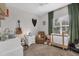 Cozy bedroom with neutral tones, featuring a comfortable armchair and plenty of natural light at 232 Explorer Dr # 15, Osprey, FL 34229