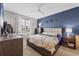 Stylish bedroom with a modern bed frame, soft carpet, and a large window for plenty of natural light at 232 Explorer Dr # 15, Osprey, FL 34229