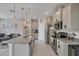 Open kitchen with granite countertops, stainless steel appliances, a large island, and tile flooring at 232 Explorer Dr # 15, Osprey, FL 34229