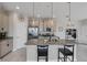 Modern kitchen with a granite island, stainless steel appliances, pendant lighting, and barstool seating at 232 Explorer Dr # 15, Osprey, FL 34229