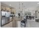Bright kitchen with granite counters, stainless appliances, bar seating, and open to the dining area at 232 Explorer Dr # 15, Osprey, FL 34229
