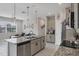 Modern kitchen featuring a granite island with a breakfast bar that opens into a cozy living space at 232 Explorer Dr # 15, Osprey, FL 34229