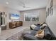 Comfortable living room with a large gray sectional, mounted TV, and neutral tile flooring at 232 Explorer Dr # 15, Osprey, FL 34229