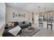 Cozy living room flowing into the kitchen with a gray sectional, decorative rug, and open layout at 232 Explorer Dr # 15, Osprey, FL 34229