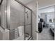 Modern glass enclosed shower with stylish tile, and built in seat that leads to the main bedroom at 232 Explorer Dr # 15, Osprey, FL 34229
