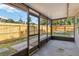 Enclosed back porch with view of fenced backyard at 2400 Stanford Ave, Bradenton, FL 34207
