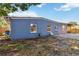 A small backyard with paver patio on a home with blue siding and white trim at 2400 Stanford Ave, Bradenton, FL 34207