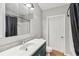 Bathroom features marble countertop, tiled flooring, shower with curtain, medicine cabinet and white door at 2400 Stanford Ave, Bradenton, FL 34207