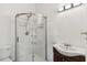 Bathroom with tiled shower, vanity, and updated fixture at 2400 Stanford Ave, Bradenton, FL 34207