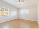 A sunlit bedroom features neutral walls, tile floors, and a ceiling fan for added comfort at 2400 Stanford Ave, Bradenton, FL 34207