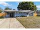 Charming single-story home featuring a covered carport, well-maintained lawn, and inviting curb appeal at 2400 Stanford Ave, Bradenton, FL 34207
