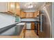 Well-lit kitchen with stainless appliances, light wood cabinets, and tile flooring at 2400 Stanford Ave, Bradenton, FL 34207