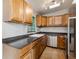 Well-appointed kitchen featuring stainless steel appliances, wooden cabinets, and dark countertops at 2400 Stanford Ave, Bradenton, FL 34207