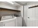 Dedicated laundry area with appliances and storage shelves at 2400 Stanford Ave, Bradenton, FL 34207