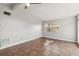 Neutral living room featuring large window, tile flooring, modern ceiling fan, and light gray walls at 2400 Stanford Ave, Bradenton, FL 34207