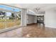 Bright living room featuring tile flooring, neutral walls, ceiling fan, and natural light streaming through large window at 2400 Stanford Ave, Bradenton, FL 34207