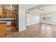 Open floorplan with tile flooring connecting the kitchen with wood cabinets to the living area and ceiling fan at 2400 Stanford Ave, Bradenton, FL 34207