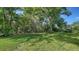 Spacious backyard with green grass and plenty of shade at 241 Willow Bend Way, Osprey, FL 34229