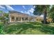 Green backyard with patio area and a screened-in patio and pool at 241 Willow Bend Way, Osprey, FL 34229