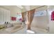 Well-lit bathroom with a shower-tub combination and decorative curtain, perfect for relaxation at 241 Willow Bend Way, Osprey, FL 34229