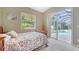 Cozy bedroom with sliding glass doors to a screened pool, offering seamless indoor-outdoor living at 241 Willow Bend Way, Osprey, FL 34229