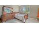 Cozy bedroom featuring natural light and a dark wood dresser with mirror at 241 Willow Bend Way, Osprey, FL 34229